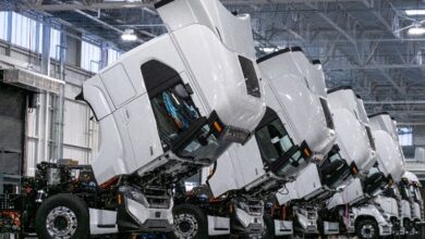 White Nikola trucks with cabs tilted forward