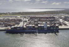 a photo of a container ship unloading imports