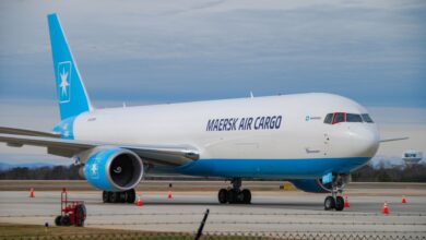 Diagonal close up of a light-blue tailed Maersk Air Cargo plane.