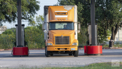 A Yellow truck at a fuel pump